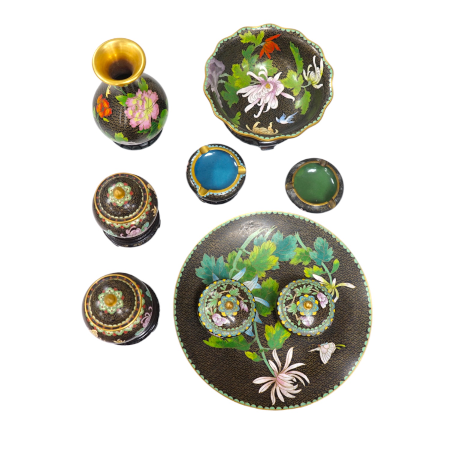 A collection of Chinese cloisonné enamel vessels, some with stands, all worked on a black background in floral designs, plate 26cm diameter. Condition - good